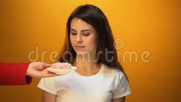 女孩选择苹果而不是甜甜圈天然糖和维生素与糖果视频的预览图