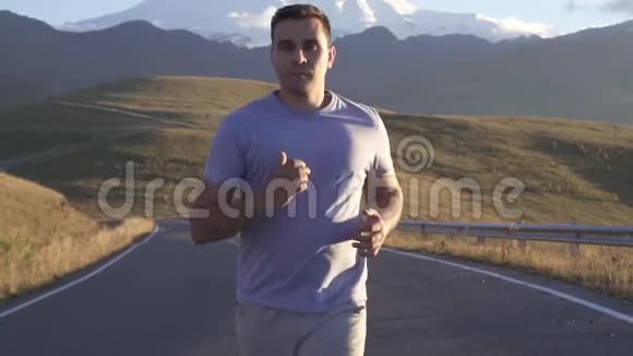 肖像男跑在通往山的路上慢悠悠地视频的预览图