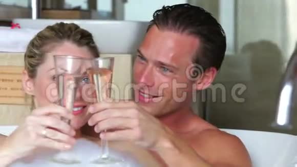 一对夫妇在沐浴中放松一起喝香槟视频的预览图