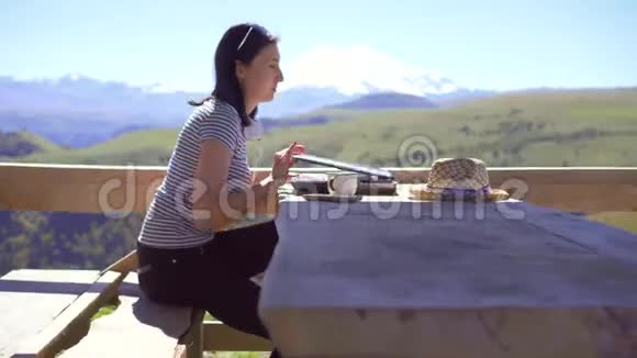 女孩是一个自由职业者在笔记本电脑上工作在山上喝着杯子视频的预览图