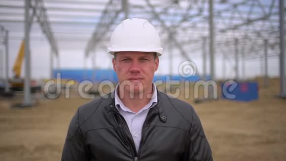 男工程师建筑师主管戴着安全帽看着施工现场的摄像机脸面视频的预览图