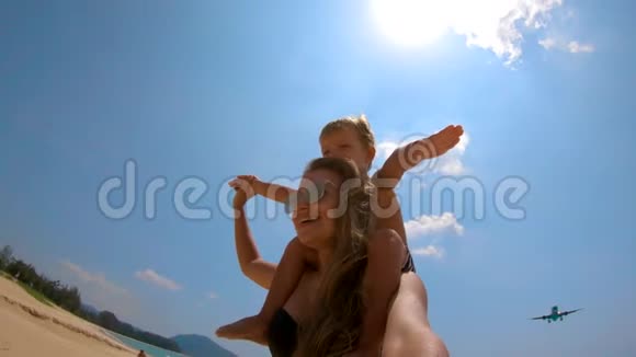 一名年轻女子和她的儿子被一架飞机从他们身上飞过的慢镜头麦考海滩普吉岛视频的预览图