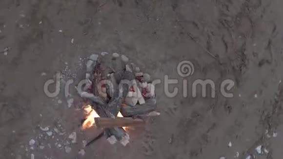 在沙滩上的旅游营地点燃篝火顶部视图视频的预览图
