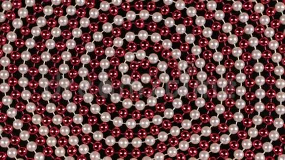 在黑色背景上由红色和白色珠子组成的螺旋旋转视频的预览图