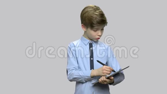 聪明的小男孩在平板电脑上工作视频的预览图