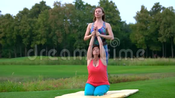 女人和女教练一起练习瑜伽视频的预览图