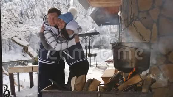 幸福的家庭在冬天的Chalet户外煮汤在一个巨大的增值税上明火视频的预览图