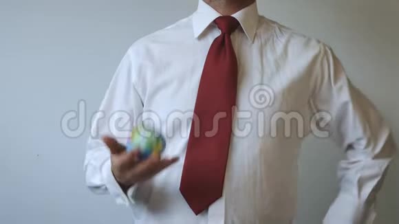 穿着红色领带的人正在扔地球视频的预览图