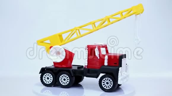 红色玩具起重机卡车与挂钩模型车旋转在白色背景视频的预览图