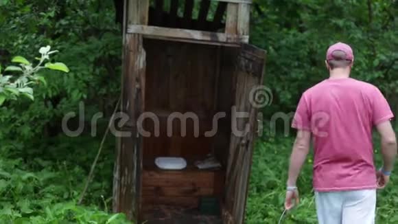 一个人把桶里的水倒在乡村厕所里视频的预览图