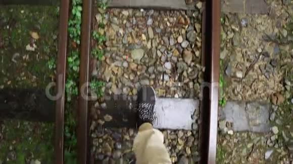 在台湾阿里山风景区森林中年轻的女游客沿着废弃的老铁路散步腿部顶部视图视频的预览图