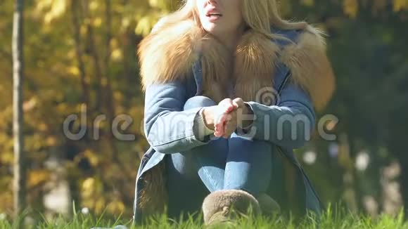 在公园里用毯子裹女朋友寒冷的秋日关怀的关系视频的预览图