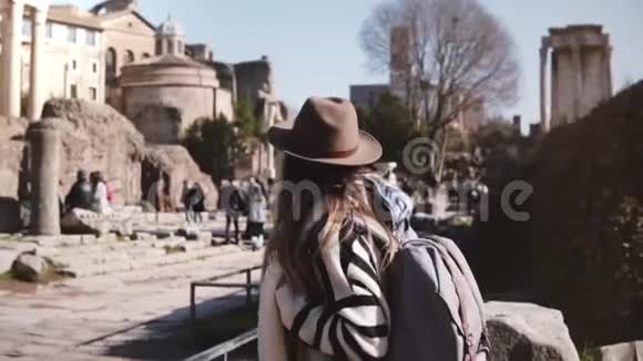 年轻的休闲放松的女游客带着背包穿着时尚的衣服在罗马论坛上散步欣赏风景视频的预览图