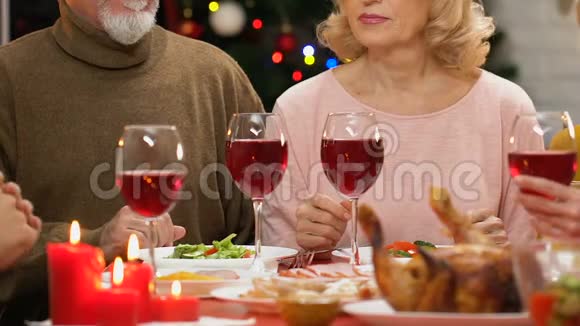 家庭在圣诞晚餐上举杯庆祝传统节日聚会视频的预览图