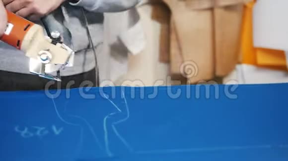 工人在工厂切割蓝色布使用特殊的仪器跟随标记关门视频的预览图