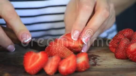 双手合拢切下新鲜的大草莓供以后使用视频的预览图