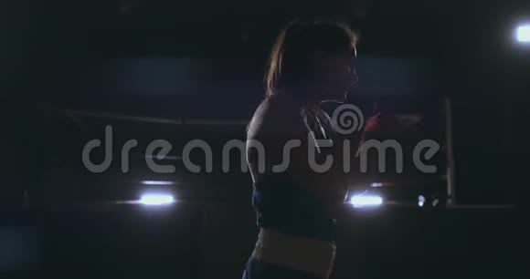 职业漂亮的女拳击手otbryvatyvat在大厅的一个黑暗的大厅里用一个影子吹着打视频的预览图