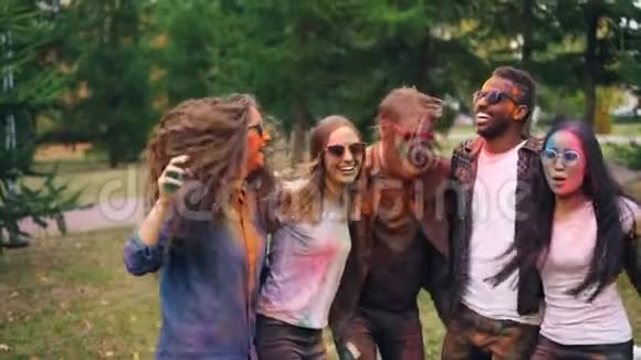 公园草坪上脸上头发上无忧无虑的年轻人在聚会上互相拥抱跳舞跳跃的画像视频的预览图