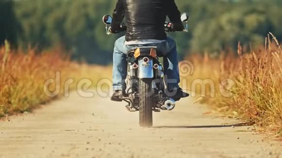 一个骑摩托车的男子骑着摩托车在麦田里视频的预览图