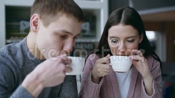 一男一女坐在咖啡馆里他们喝茶他们相爱了恋爱中的情侣视频的预览图