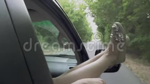 女人的腿伸在车窗外女人的腿伸在车窗外愉快的消遣视频的预览图