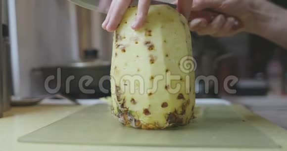手拿刀在餐桌上切菠萝视频的预览图