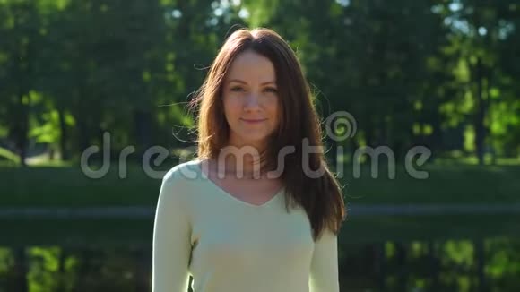 女人把闪亮的长发披在绿叶上视频的预览图