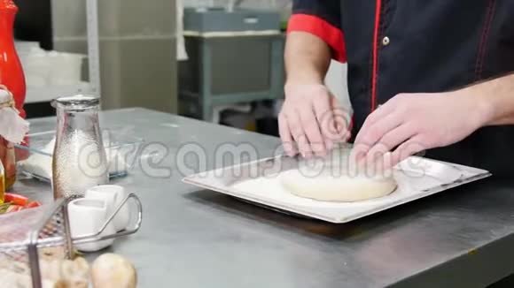 餐厅厨房一个人用面粉擀成面团准备披萨视频的预览图