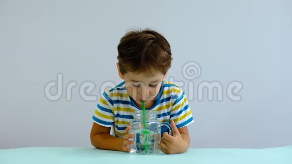 慢动作亚洲可爱的小孩在厨房里喝水开朗的男孩喜欢吹泡泡视频的预览图