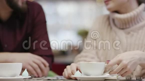 成年男子和女友坐在餐厅用NFC技术在智能手机上支付账单视频的预览图