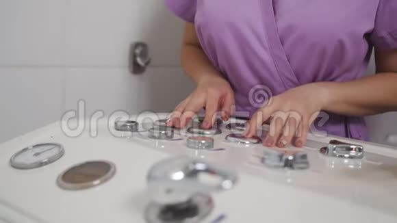 女人控制水疗按摩浴缸做按摩客户躺在浴缸里女性操作员通过视频的预览图