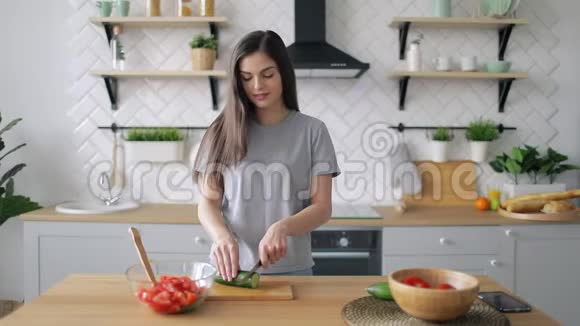 快乐女孩在厨房切蔬菜视频的预览图