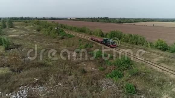 一列小火车头和一辆拖车在乡下空中射击视频的预览图