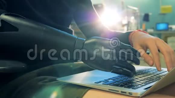 在笔记本电脑键盘上人工手打字cyborg概念视频的预览图