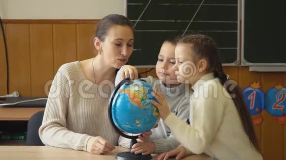 老师教孩子们使用地球仪视频的预览图