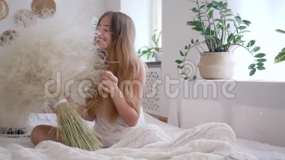 无过敏快乐的女孩捧着一束羽毛草享受周末的休闲时光视频的预览图