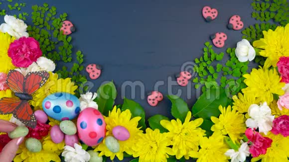 复活节在深蓝色的木头上用文字展示新鲜的春花视频的预览图