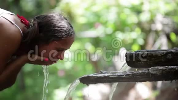清水流入女人手年轻女子在大自然中洗了脸1920x1080视频的预览图