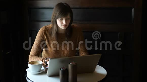 有笔记本电脑的咖啡厅的女孩视频的预览图