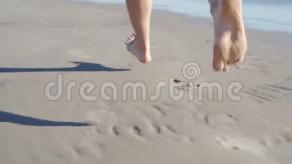 低潮低潮关闭DOF无法辨认的女人在炎热的夏天阳光下沿海岸奔跑免费女孩视频的预览图