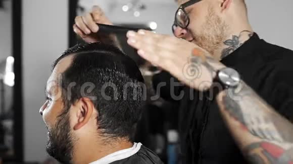 理发师在理发店理发后用发胶给顾客做发型男士理发和剃须视频的预览图