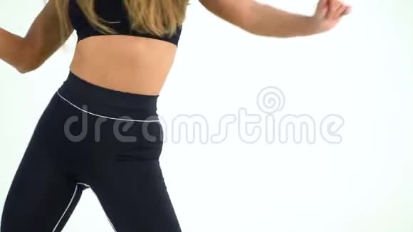 穿着黑色运动服跳舞微笑的运动女人视频的预览图