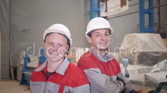 肖像工人在仓库里用起重机工作微笑着看着相机生产通风和视频的预览图