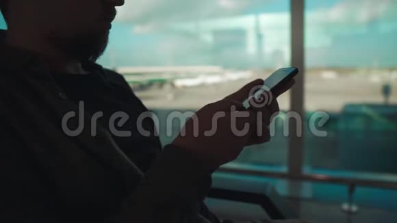在机场坐着的手机传感器屏幕上有人在刷卡特写镜头视频的预览图