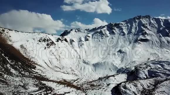 巨大的群山覆盖着雪山峰全景蓝天视频的预览图