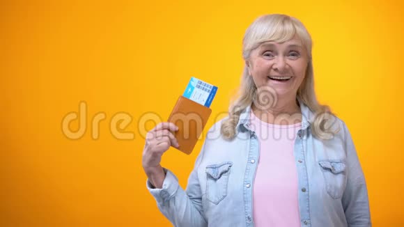 快乐退休女士出示护照和机票旅行社广告视频的预览图