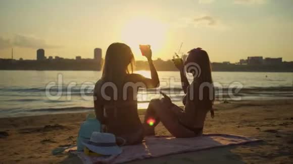 女孩们在日落时放松和享受一杯视频的预览图