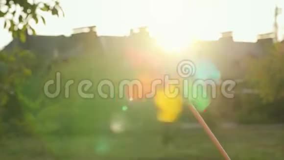 塑料彩虹风车在夕阳下旋转视频的预览图