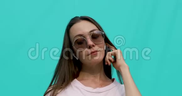 戴着耳机太阳镜的年轻女人视频的预览图