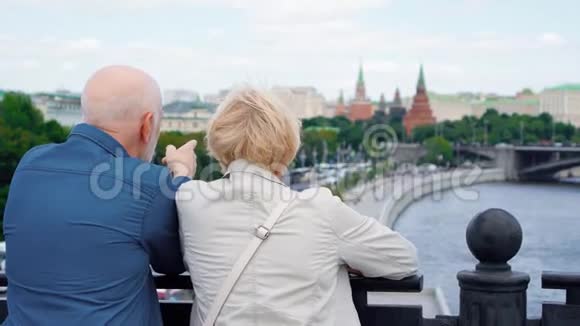 老两口的后景站在观景台上环视城市退休人员在俄罗斯旅行视频的预览图